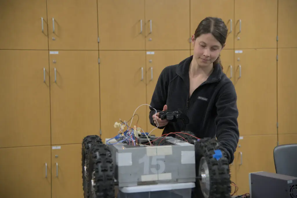 Sara Centeno spins the wheels on the Biological Assistant Beach Surveyer (BABS) her team has built.