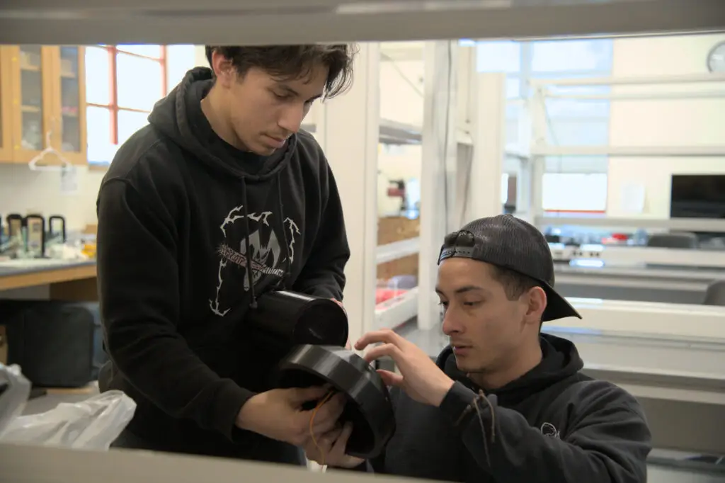 Sebastian Guerrero Mejia and Angel Martinez assemble their solar-tracking robotic mount, which holds a solar panel to face the sun.